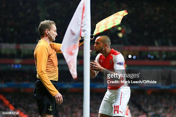 Theo Walcott of Arsenal argues with the linesman during the UEFA Champions League round of 16, first leg match between Arsenal and Monaco at The...