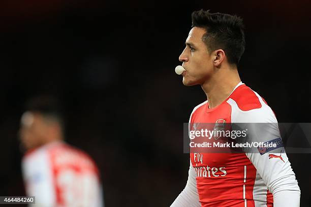 Alexis Sanchez of Arsenal blows a bubble with his gum during the UEFA Champions League round of 16, first leg match between Arsenal and Monaco at The...