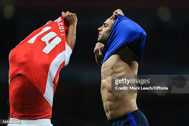 Theo Walcott of Arsenal swaps shirts with Aymen Abdennour of AS Monaco during the UEFA Champions League round of 16, first leg match between Arsenal...