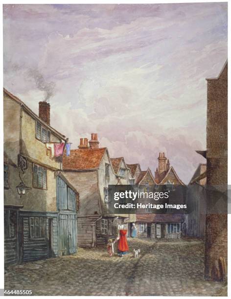 View of a woman and a child walking down Crown Court, Bermondsey, London, c1825.