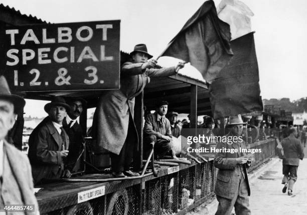 The RTS British Grand Prix, Brooklands, 1927. A man waving a flag from the Talbot pits.