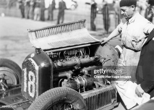 Attilio Marinoni, chief mechanic of Scuderia Ferrari, with an Alfa Romeo, 1934. Scuderia Ferrari raced Alfa Romeo cars in the 1930s. It was not until...