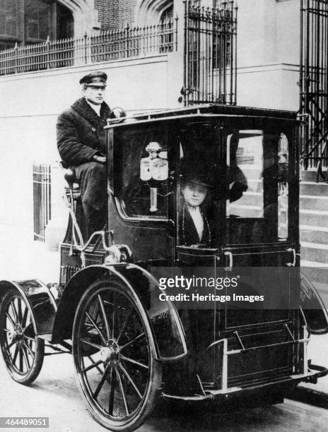 Woman passenger in a 1910 taxi cab, New York, USA, .