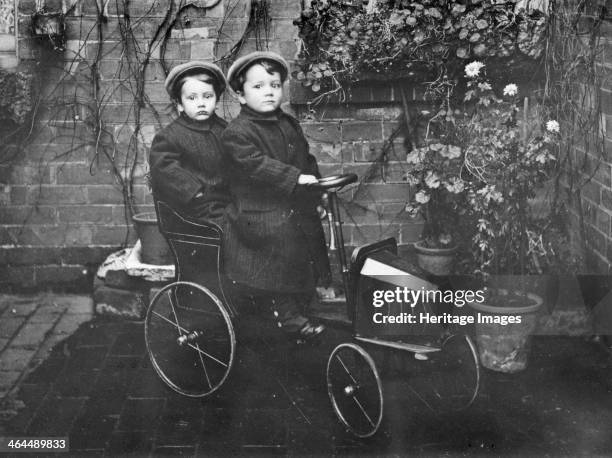 Two boys in a pedal car, .