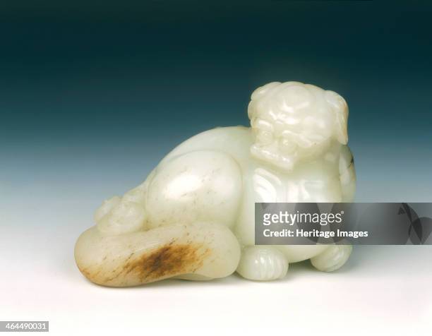 Jade lion dog, probably Kangxi period, early Qing dynasty, China, 1662-1722. A large and fine white jade lion dog with a few brown suffusions.Its...