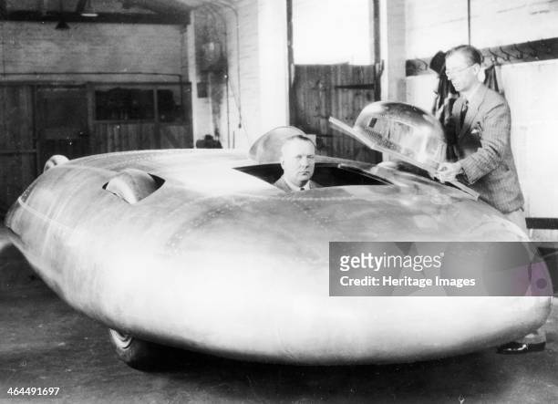 Railton Special Land Speed Record car, Brooklands, Surrey, 1938. John Cobb is pictured in the car with its designer, Reid Railton, standing alongside...