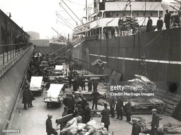 Cargo being loaded or unloaded from a ship, Royal Victoria Dock, Canning Town, London, c1930. The dock was built between 1850 and 1855 on an area of...