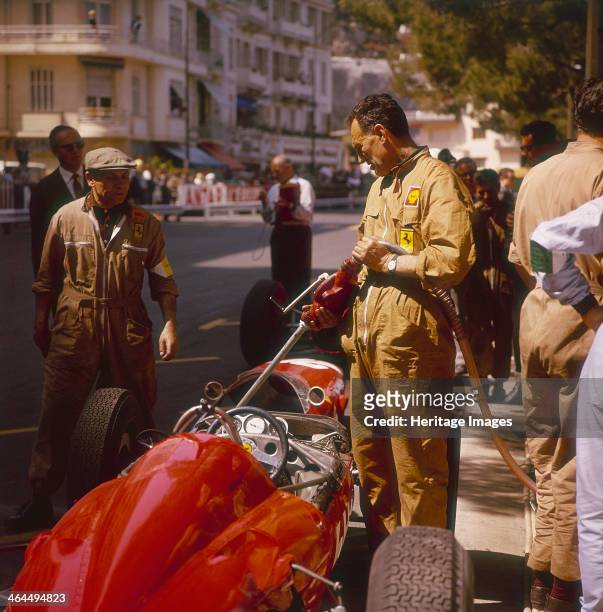 Ferrari team member filling a car with fuel, Monaco Grand Prix, Monte Carlo, 1963.