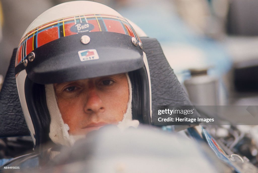 Jackie Stewart at the wheel of a racing car.