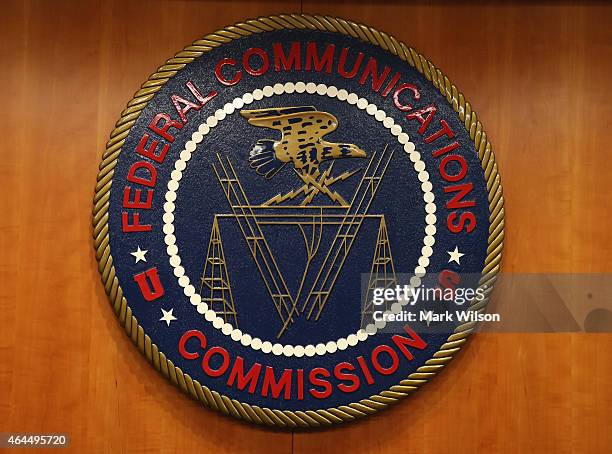 The seal of the Federal Communications Commission hangs inside the hearing room at the FCC headquarters February 26, 2015 in Washington, DC. The...