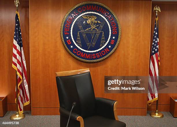 The seal of the Federal Communications Commission hangs behind commissioner Tom Wheeler's chair inside the hearing room at the FCC headquarters...