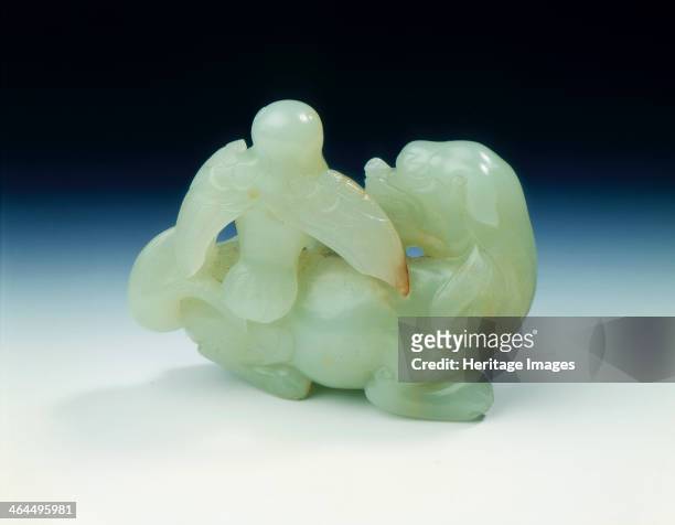 Jade mythological animal with an eagle perched on its back, Ming dynasty, China, 1368-1644. A pale celadon-green jade group of mythical animal in...