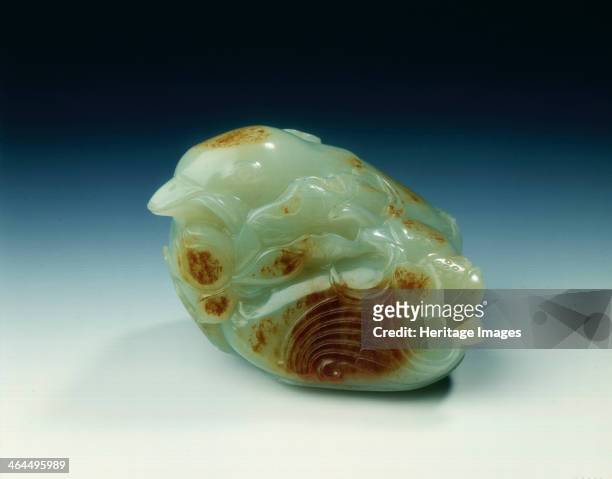 Jade mandarin ducks with lotus, Qing dynasty, China, probably 18th century. A pale celadon-green pebble carved in the shape of two mandarin ducks...