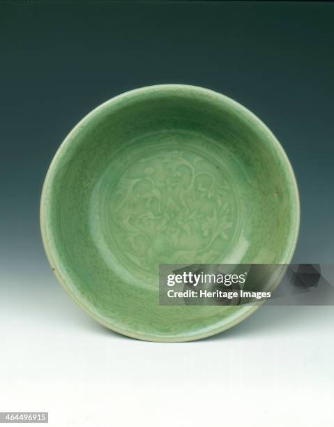 Carved celadon bowl, early Ming dynasty, China, 15th century. A small carved celadon bowl of broad shallow form. The interior is delicately incised...