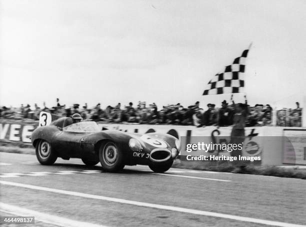 Ken Wharton in a Jaguar D Type passing the chequered flag during the Rheims 12 Hours Race, France, 3rd July 1954. Wharton shared the car with Peter...