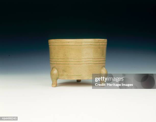 Celadon tripod censer, China or Vietnam, 11th-13th century. Circular deep straight-sided censer with bright yellowish-green glassy crackled glaze....