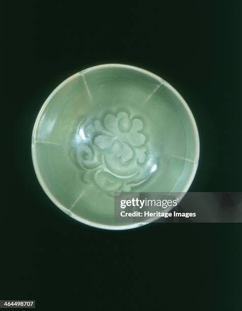 Yaozhou celadon bowl with peony design, Jin dynasty, China, 1127-1234. Small lightly foliated Yaozhou celadon bowl, carved in the interior with...