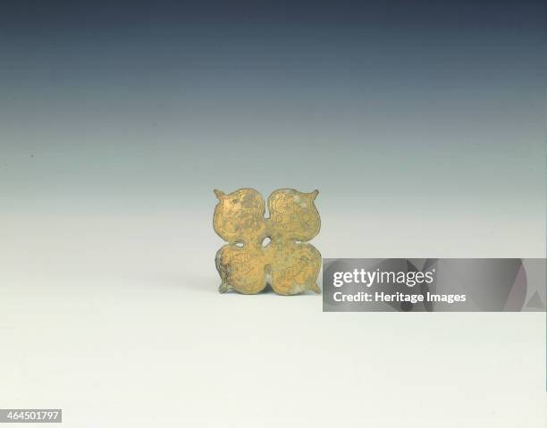 Quadrafoil applique with prancing horned sheep, Han dynasty, China, 206 BC-220 AD. A gilt bronze quadrafoil applique, each leaf in the shape of a...
