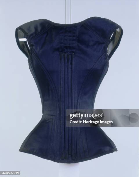 Black corset with a grey lining, c1881-c1885. The corset is strongly boned throughout, possibly with whalebone, and is thought to have been an...