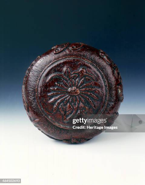 Dessicated orange skin box of bombe form. The circular orange-skin cover is moulded in relief with a daisy-like floral spray. The container itself is...