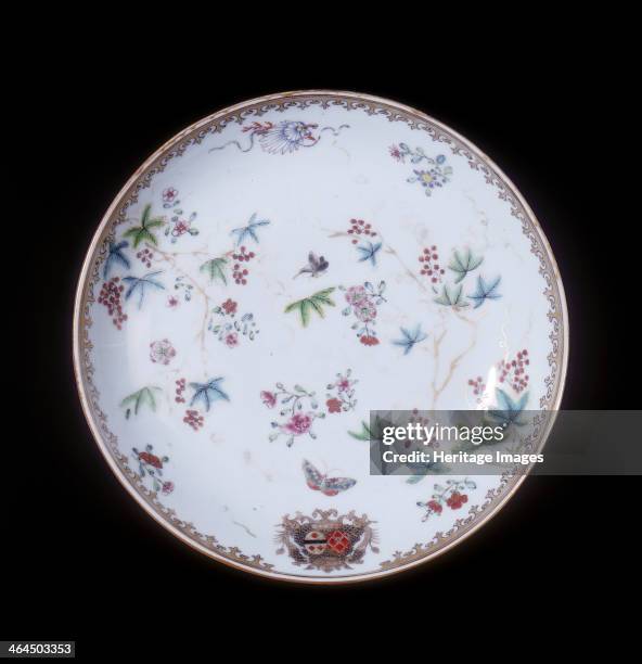 Famille rose continental armorial plate, Qing dynasty, China, 1750-1775. A famille rose armorial plate decorated with scrolling vines with red...