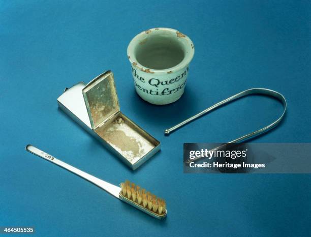 Toothbrush, box of dental powder and tongue-scraper, 18th century. Silver toothbrush, box of powder for cleaning teeth, a device for scraping the...