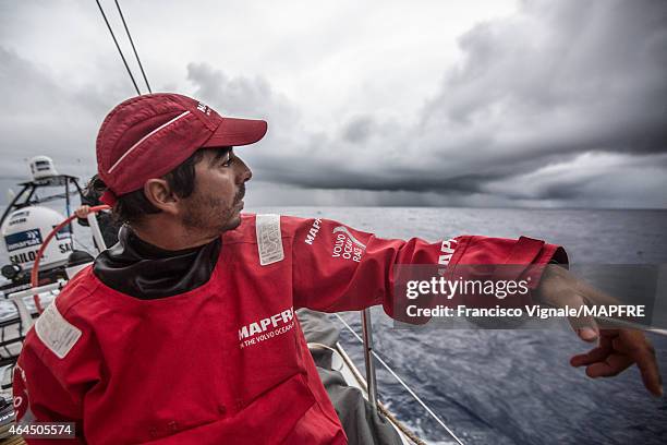 In this handout image provided by the Volvo Ocean Race onboard MAPFRE, Andre Fonseca looks out at the nasty clouds between him and Auckland during...