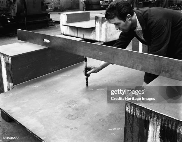 An engineer at work at the Edgar Allen Steel Foundry, Sheffield, South Yorkshire, 1962. An engineer using a precision depth guage to quality check a...