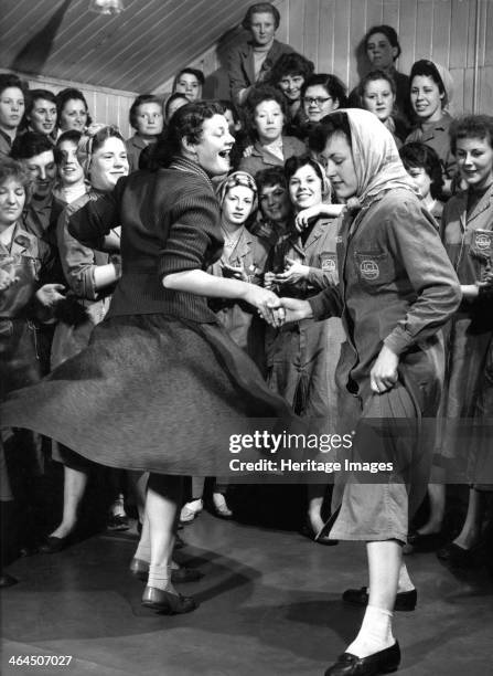 Female ICI employees enjoy a dance, South Yorkshire, 1957. A couple of girls from the ICI Detonator factory in Denaby Main take a break from...