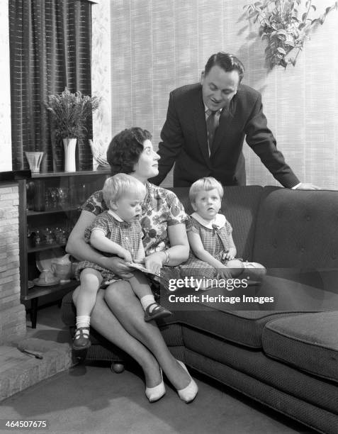 Family group looking at a brochure, Doncaster, South Yorkshire, 1963.