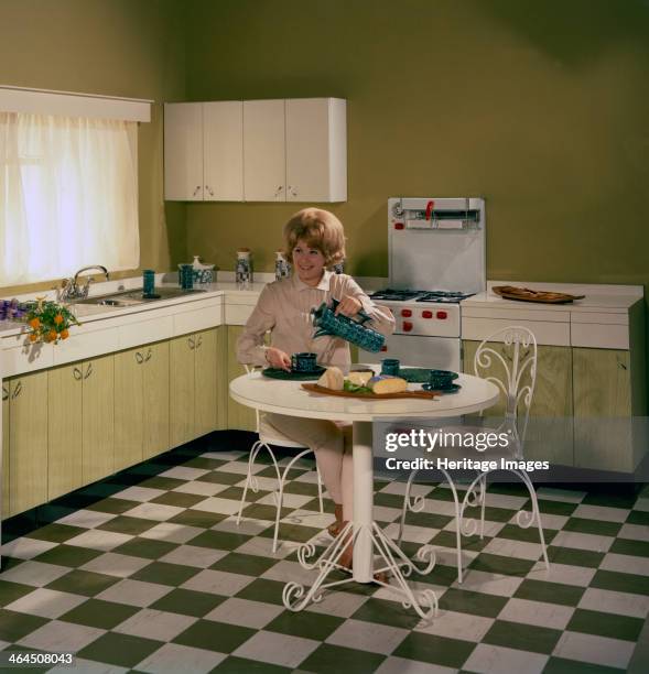 Kitchen scene, Warwick, Warwickshire, 1966. In this advertising image a model is seen pouring a coffee. The kitchen design was new at the the time,...