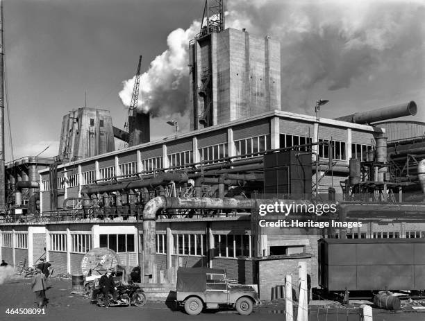 Manvers coal processing plant, Wath upon Dearne, near Rotherham, South Yorkshire, January 1957. A worker leans against what looks to be an early...