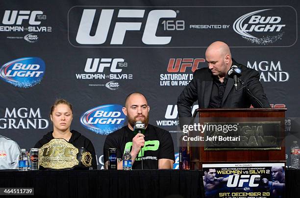 Travis Browne answers questions from the media with Ronda Rousey and UFC President Dana White on stage at the UFC 168 post fight press conference at...