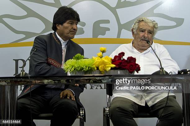 Uruguay's President Jose Mujica and his Bolivian counterpart Evo Morales speak with press after signing agreements in Montevideo on February 26 two...