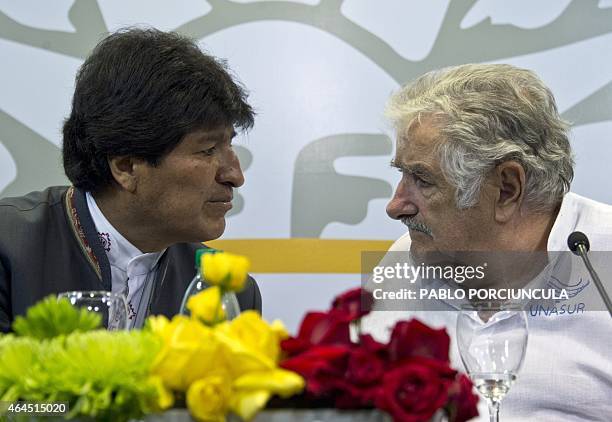 Uruguay's President Jose Mujica speaks with his Bolivian counterpart Evo Morales after signing agreements in Montevideo on February 26 two days...