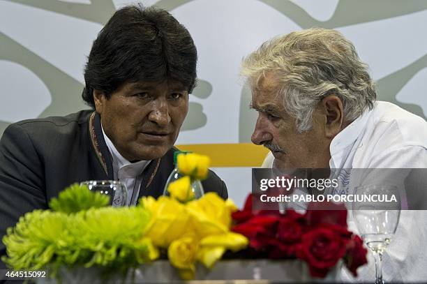 Uruguay's President Jose Mujica speaks with his Bolivian counterpart Evo Morales after signing agreements in Montevideo on February 26 two days...