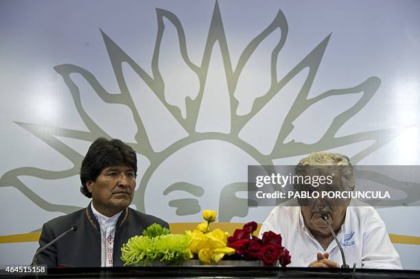 Uruguay's President Jose Mujica and his Bolivian counterpart Evo Morales speak with press after signing agreements in Montevideo on February 26 two...