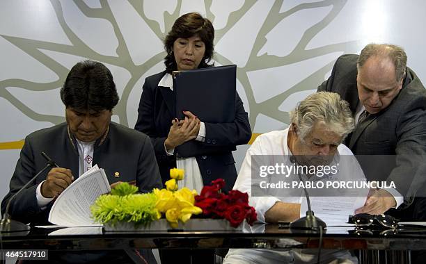 Bolivia's President Evo Morales and Uruguay's President Jose Mujica sign agreements in Montevideo on February 26 two days before newly elected...