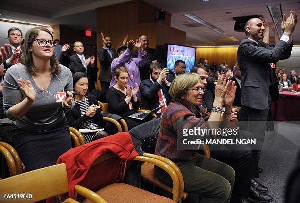 Attendees applaud after Federal Communications Commission Chairman Tom Wheeler announced the FCC ruling on net neutrality on February 26, 2015 in...