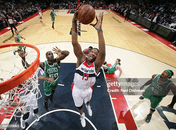 Kevin Seraphin of the Washington Wizards rebounds against Joel Anthony of the Boston Celtics during the game at the Verizon Center on January 22,...