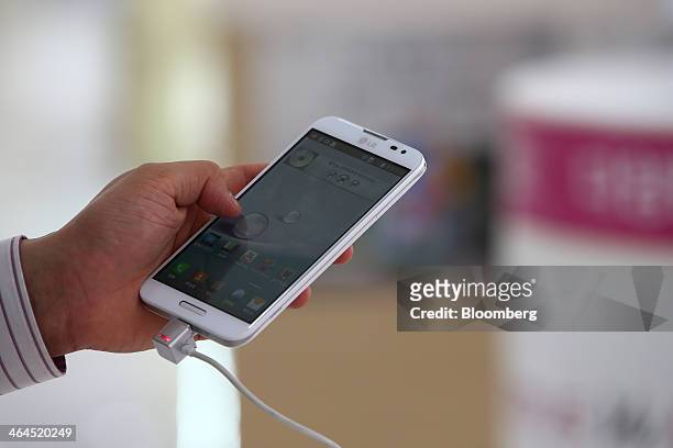An employee demonstrates an LG Electronics Inc. Optimus G Pro smartphone at the company's Bestshop store in Seoul, South Korea, on Wednesday, Jan....