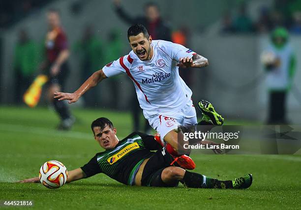 Vitolo of Sevilla is tackled by Granit Xhaka of Borussia Moenchengladbach during the UEFA Europa League Round of 32 second leg match between Borussia...