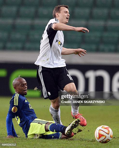 Ajax Amsterdam's South African midfielder Thulani Serero and Legia Warszawa's Michal Maslowski vie for the ball during the round of 32, second leg...