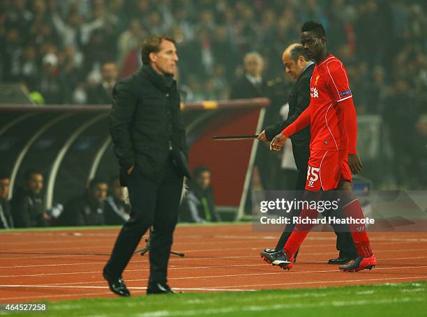 Mario Balotelli of Liverpool looks across as Brendan Rodgers manager of Liverpool as he is substituted during the UEFA Europa League Round of 32...