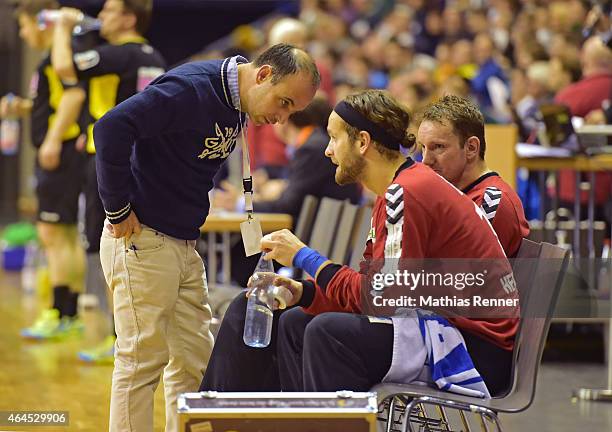 Manager Bob Hanning of Fuechse Berlin talks to Silvio Heinevetter of Fuechse Berlin during the game between Fuechse Berlin and TBV Lemgo on February...