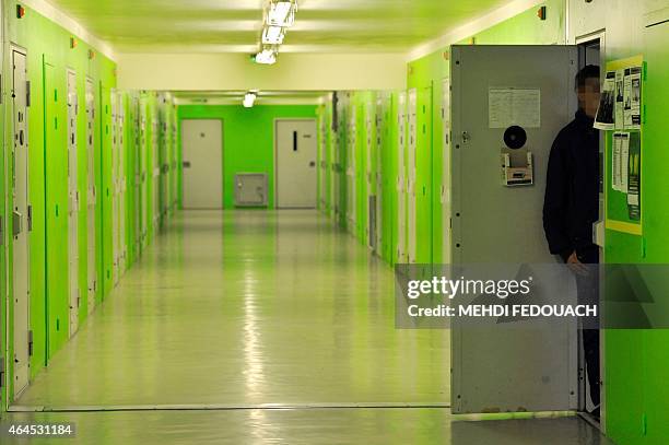 This photo taken on February 26, 215 at Mont-de-Marsan's Pemegnan prison shows an inmate standing by his cell door opened, in a so-called "respect...