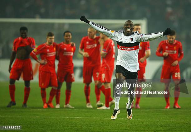 Liverpool players look dejected as Demba Ba of Besiktas celebrates as Dejan Lovren of Liverpool misses the decisive kick in the penalty shoot out...