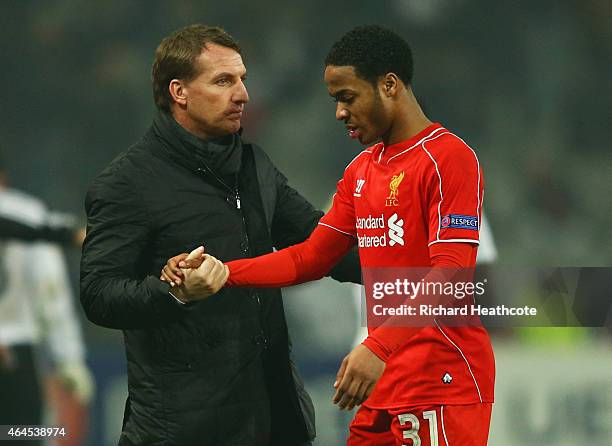 Brendan Rodgers manager of Liverpool shakes hands with Raheem Sterling of Liverpool after defeat in a penalty shoot out during the UEFA Europa League...