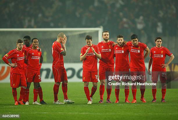 Liverpool players look dejected as Dejan Lovren of Liverpool misses the decisive kick in the penalty shoot out during the UEFA Europa League Round of...