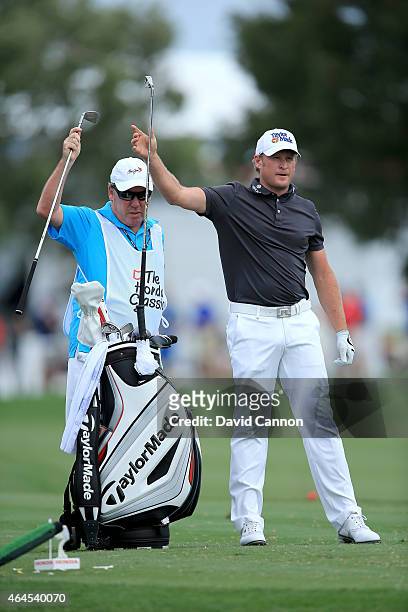 Jamie Donaldson of Wales decides on his club for his tee shot on the par 3, fifth hole with his caddie Mick Donaghyduring the first round of The...